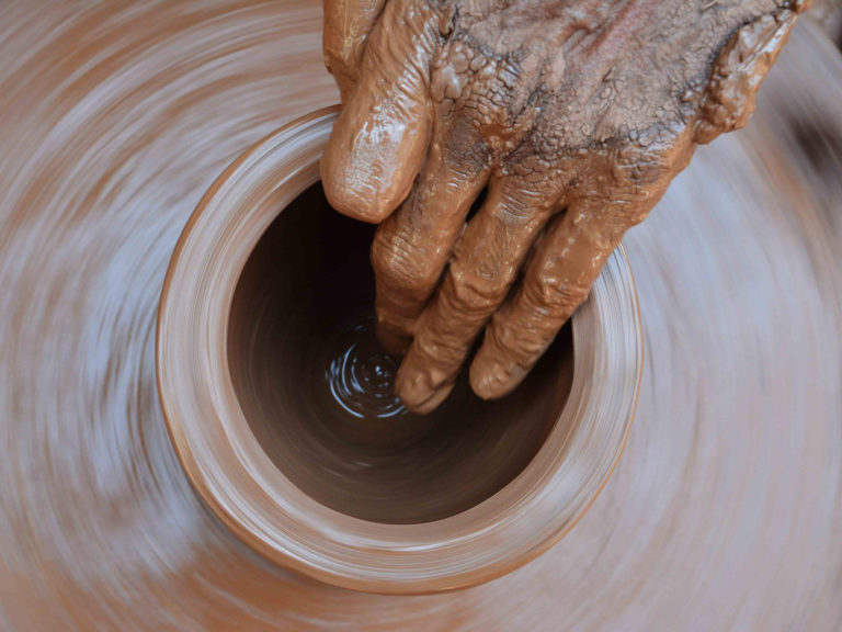 Pottery throwing clay on a wheel