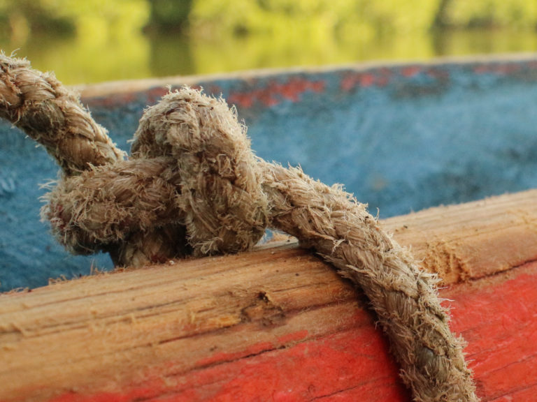 A knotted rope on a boat gunnel