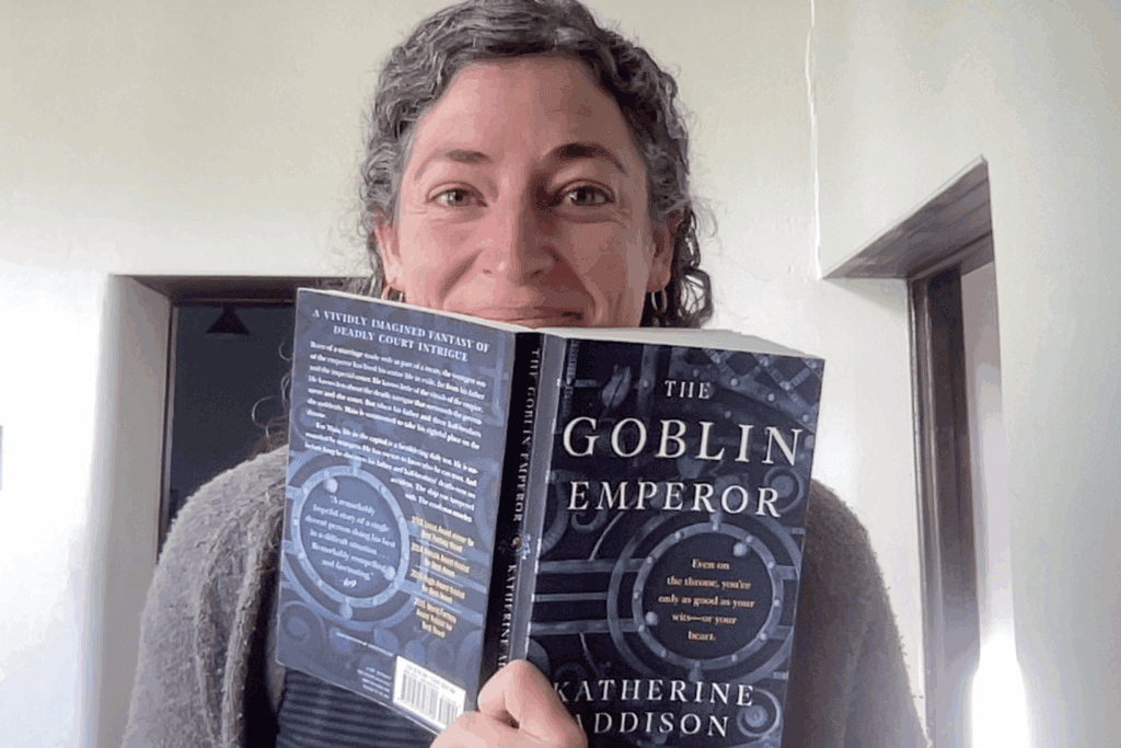 Yvonne with one of her favorite books, "The Goblin Emperor" by Katherine Addison. It is considered hopepunk fantasy by some.